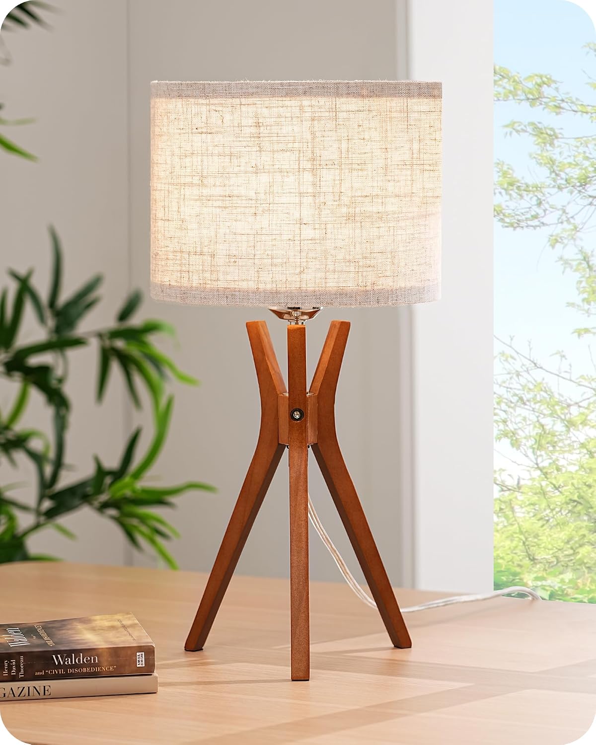 Mid-century style table lamp — featuring a dark wood base and a beige linen shade.