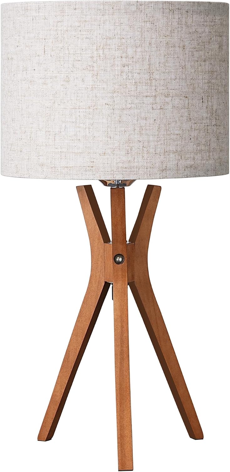 Mid-century style table lamp — featuring a dark wood base and a beige linen shade.